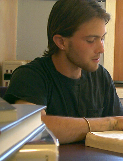 Young man reading a book.